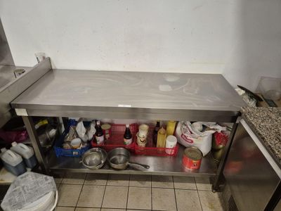 a kitchen with a stainless steel counter and a sink