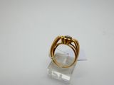 a close up of a gold ring on a clear stand