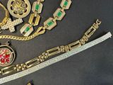 a lot of gold jewelry on a black surface