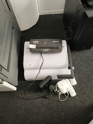an image of a printer and other electronics on the floor