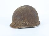 an old helmet on a white surface with a white background
