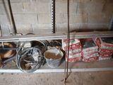 a metal shelf with a bunch of tools on top of it