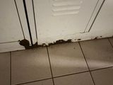 a hole in the floor next to a door