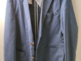 an image of a blue jacket hanging on a hanger on a wall