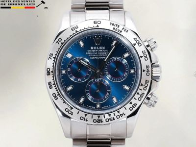 une montre en argent avec un cadran bleu sur fond blanc