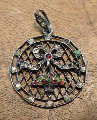 a close up of a pendant on a wooden surface