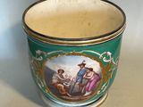 a green cup with a picture of a man and a woman on it