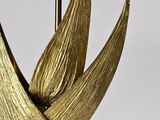 gold leaf table lamp with a metal base and a gold shade
