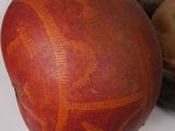 a red ball with a design on it next to some other objects