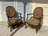 two chairs sitting next to each other on the sidewalk