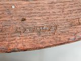 a close up of a piece of wood with writing on it