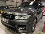 an image of a grey range rover parked in a garage