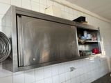 a large stainless steel oven in the middle of a kitchen