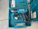 a blue tool in a blue case on the ground