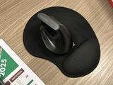 a mouse and a mouse pad on a desk next to a keyboard