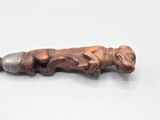 a small metal object with a dog on it