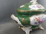 a green and white bowl with a bird on it