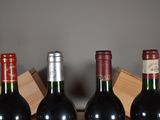 three bottles of wine are lined up in a row on a table