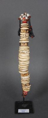 statue d'une femme vêtue d'une robe faite de coquillages et de perles