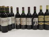 several bottles of wine are lined up in a row on a table
