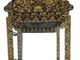 mirror with ornate design on top of it on a white surface