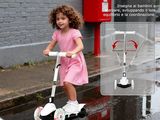 a little girl that is riding a scooter on the street