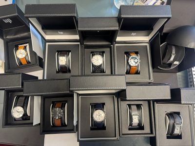 a lot of watches that are sitting in a box