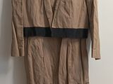 brown dress hanging on a hanger in a room