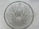 a glass bowl with a design on it on a table