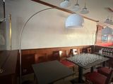 a table with wine glasses on it in the corner of a room