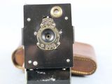 a small camera with a leather case on it