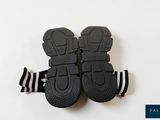 two pairs of black shoes with white stripes on them