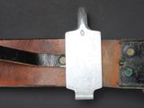 a knife that is laying on top of a piece of leather