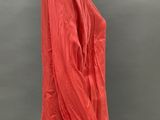 an image of a mannequin wearing a red shirt and black pants