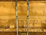 a pair of tongs in a case on a table