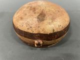an old wooden box with a brown stripe around it