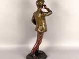bronze figurine of a man talking on a cell phone
