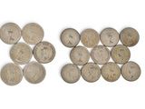 some old coins are arranged in a row on a white surface