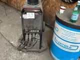 a picture of a small portable welding machine and a can of water