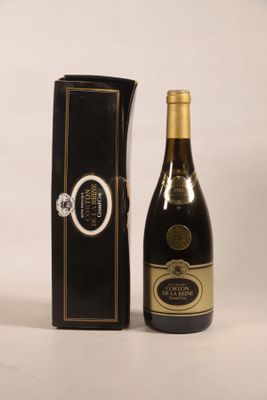 a bottle of wine sitting next to a black box