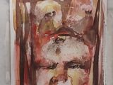 une peinture représentant le visage d'un homme sur une feuille de papier