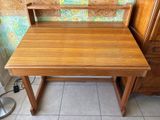 a small wooden desk with a chair on top of it
