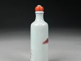 a white and blue glass snuff bottle with a fish on it