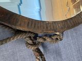 a rope wrapped around a mirror on the floor