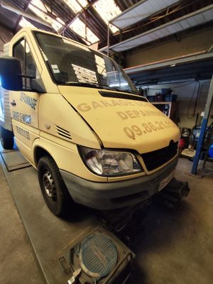 a van that is parked in a garage with the door open