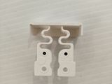 two pieces of white plastic are attached to a wall