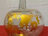 a glass vase with a gold leaf design on it