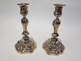 pair of silver candlesticks on a white background