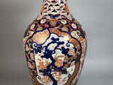 a vase with a blue and orange design on it
