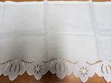 a table with a white table cloth and a pair of scissors on it
